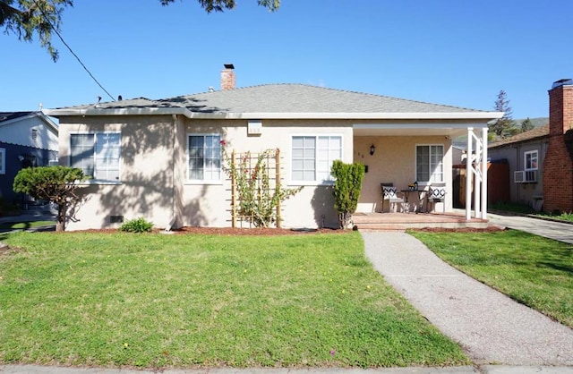 view of front of property with a front yard and covered porch