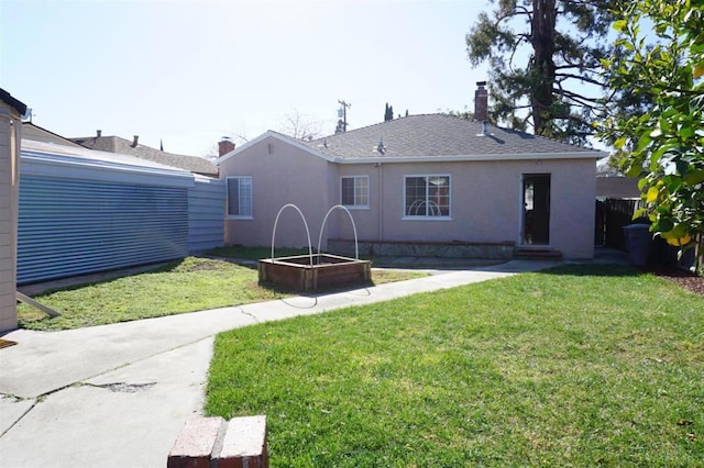 rear view of property with a yard