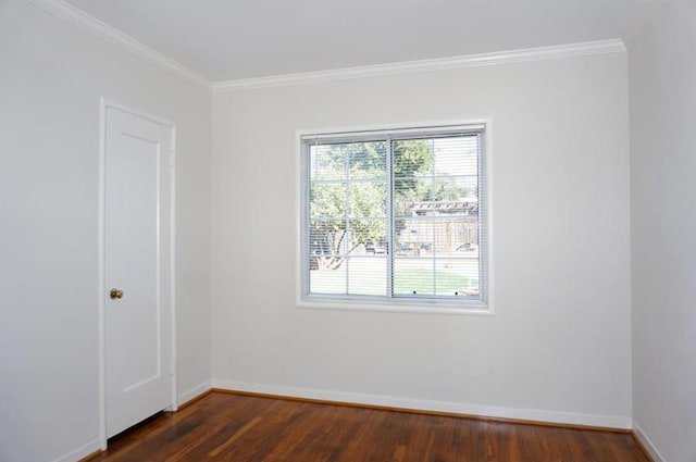 empty room with ornamental molding, dark hardwood / wood-style floors, and a healthy amount of sunlight