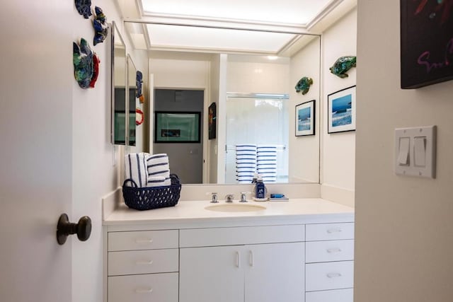 bathroom with vanity and a shower with door