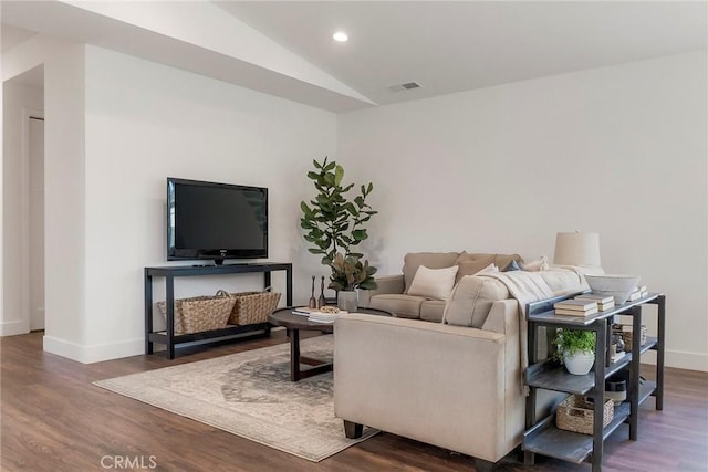 living room featuring hardwood / wood-style flooring and vaulted ceiling