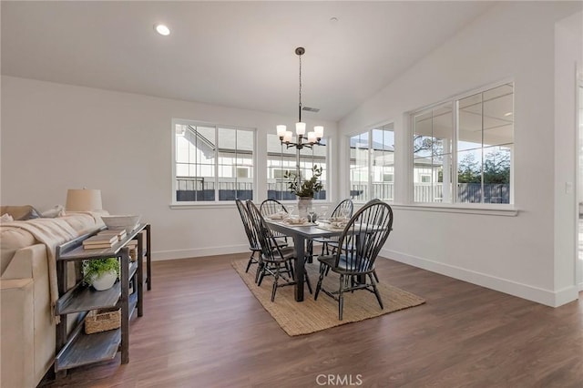 dining room featuring an inviting chandelier, lofted ceiling, and dark hardwood / wood-style flooring