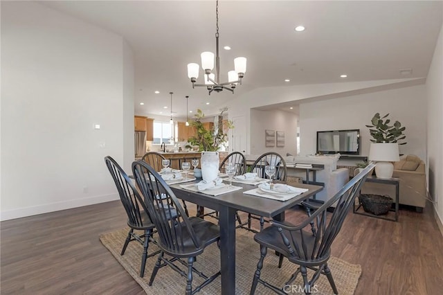 dining space featuring lofted ceiling, dark wood-type flooring, and a notable chandelier