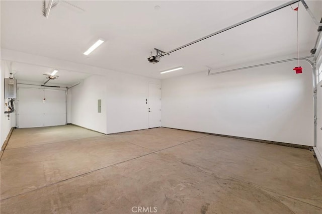 garage featuring a garage door opener, electric panel, and water heater