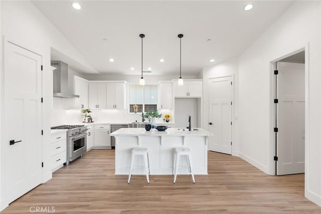 9 Harkness Ct, Chico, CA 95973 - kitchen featuring wall chimney exhaust hood, appliances with stainless steel finishes, white cabinets, recessed lighting, and light countertops