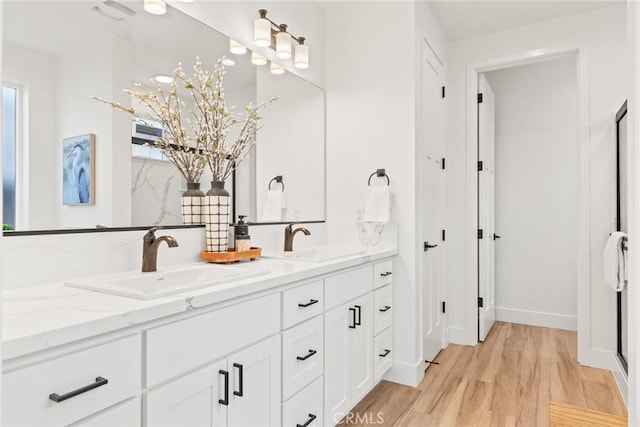 9 Harkness Ct, Chico, CA 95973 - full bath with double vanity, wood finished floors, and baseboards