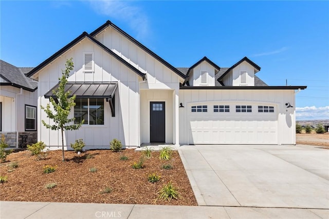 9 Harkness Ct, Chico, CA 95973 - modern inspired farmhouse featuring board and batten siding, an attached garage, and driveway