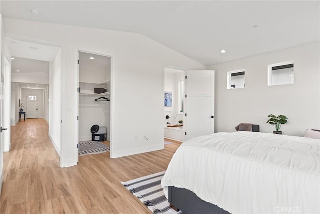 9 Harkness Ct, Chico, CA 95973 - bedroom featuring light wood finished floors, vaulted ceiling, a walk in closet, ensuite bathroom, and a closet