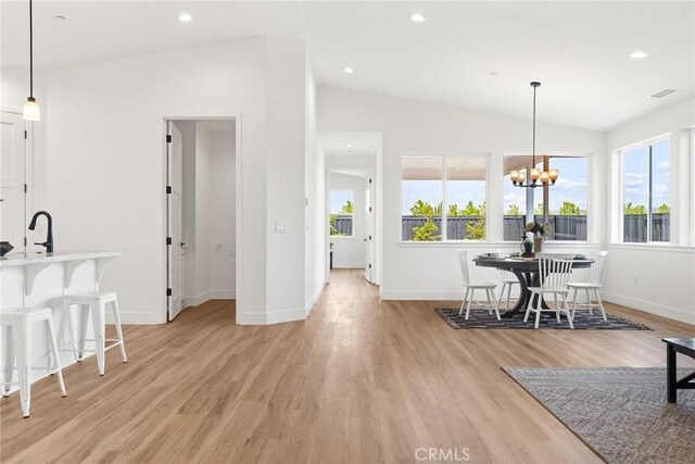 9 Harkness Ct, Chico, CA 95973 - dining space featuring vaulted ceiling, light wood finished floors, baseboards, a chandelier, and recessed lighting