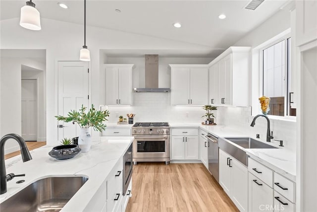 9 Harkness Ct, Chico, CA 95973 - kitchen featuring appliances with stainless steel finishes, wall chimney exhaust hood, a sink, decorative backsplash, and recessed lighting