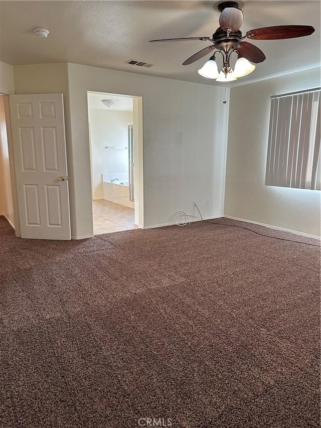 carpeted spare room with ceiling fan