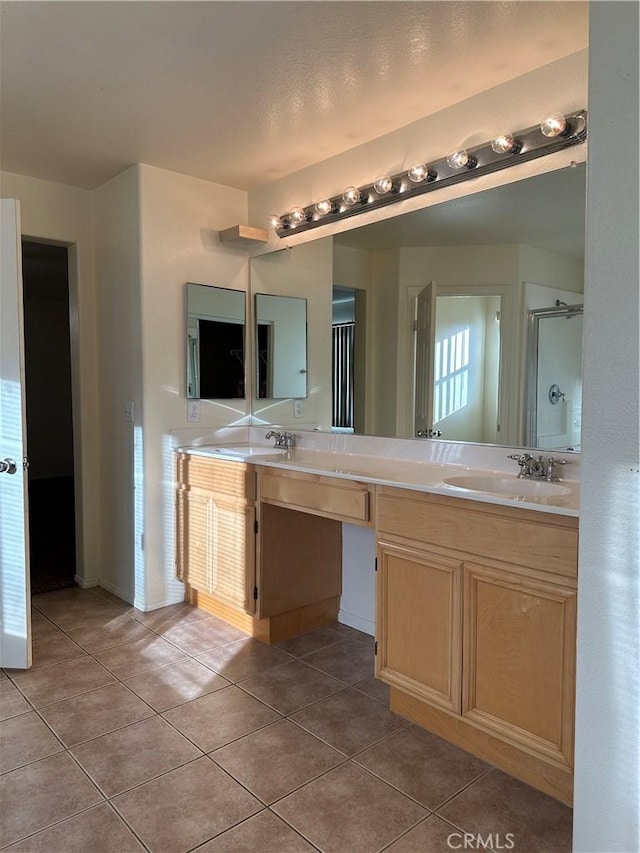 bathroom featuring tile patterned flooring, vanity, and an enclosed shower