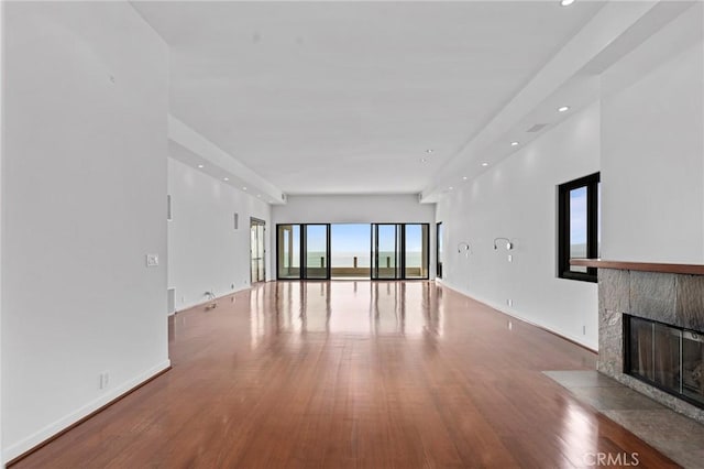 unfurnished living room with hardwood / wood-style flooring and a fireplace