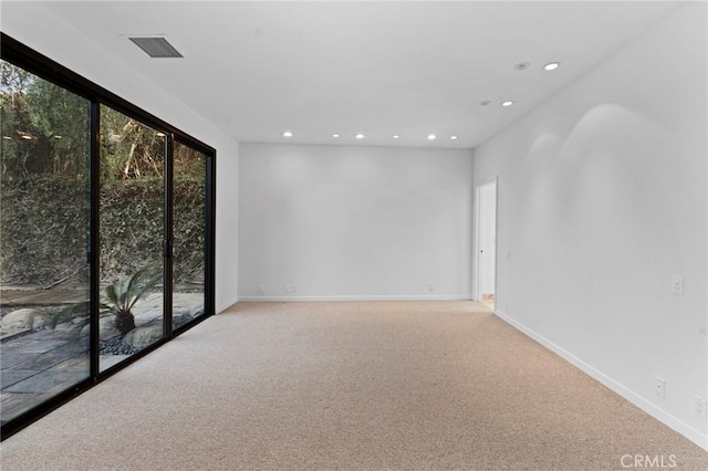 unfurnished room with light colored carpet