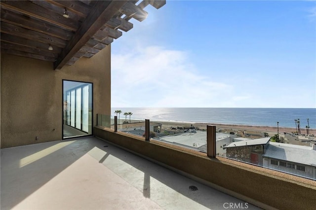 balcony featuring a beach view and a water view