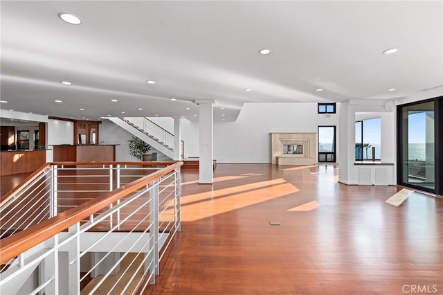 interior space with hardwood / wood-style flooring, a fireplace, and ornate columns