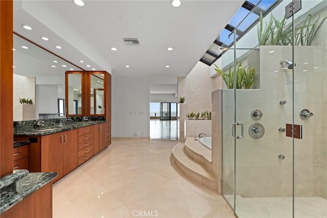 bathroom featuring shower with separate bathtub and vanity