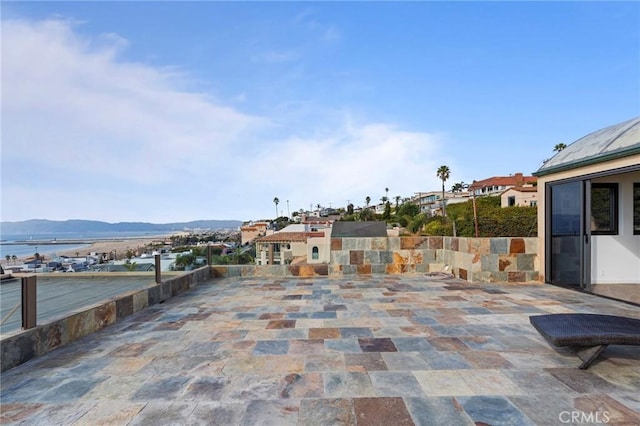 view of patio featuring a water and mountain view