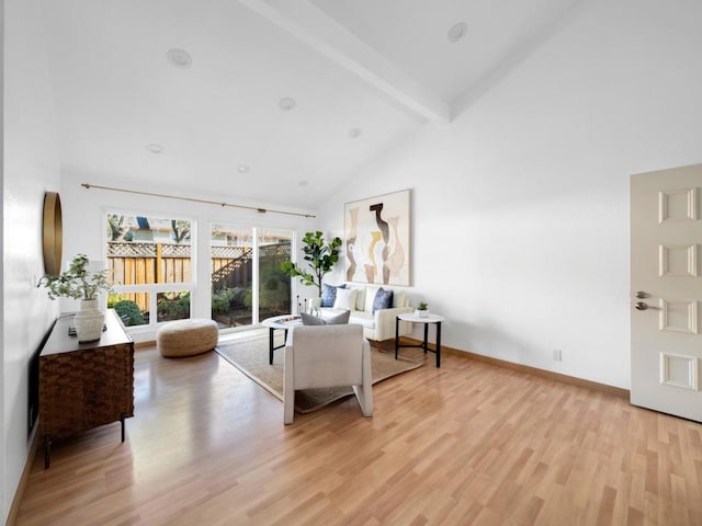 living room with beam ceiling, high vaulted ceiling, and light wood-type flooring