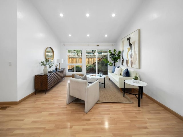 living room featuring light hardwood / wood-style flooring and high vaulted ceiling