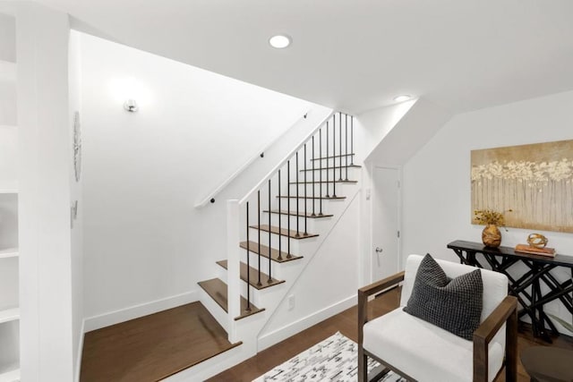 stairs featuring hardwood / wood-style floors