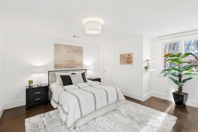 bedroom with dark hardwood / wood-style floors