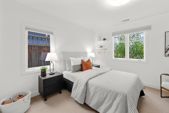 bedroom featuring light carpet