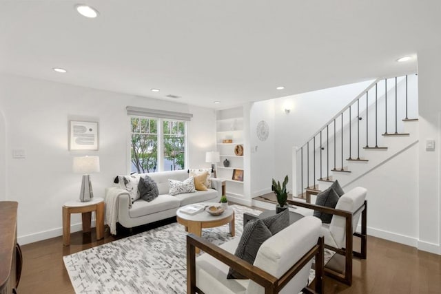 living room with dark hardwood / wood-style flooring