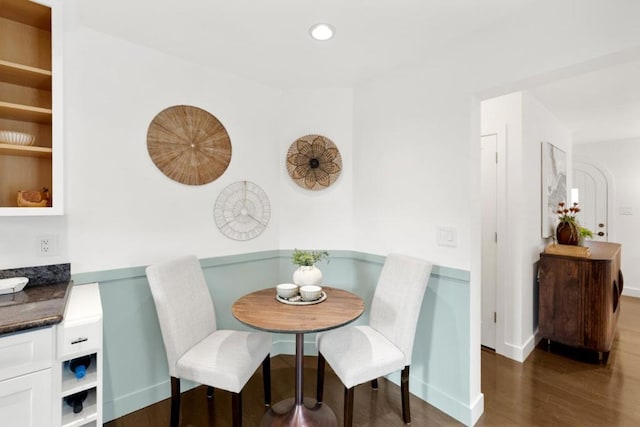 dining area featuring breakfast area and dark hardwood / wood-style flooring