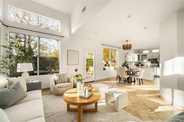 living room with a healthy amount of sunlight and a towering ceiling