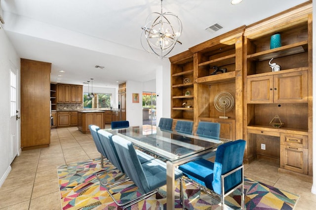 dining room with light tile patterned flooring and a chandelier