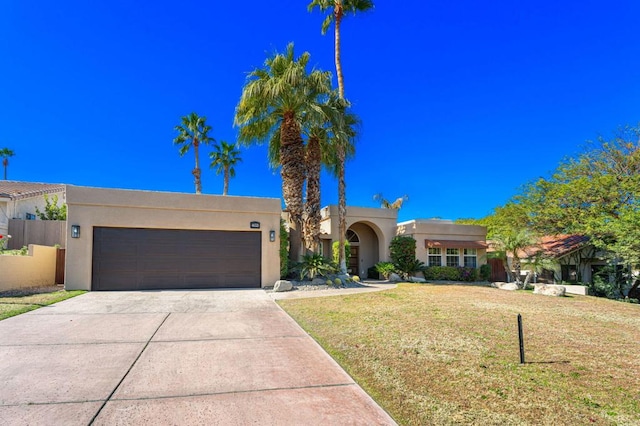 view of front facade featuring a garage and a front lawn