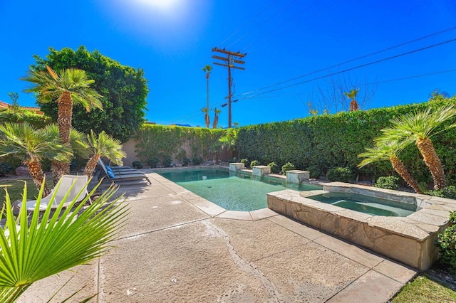 view of pool featuring an in ground hot tub and a patio