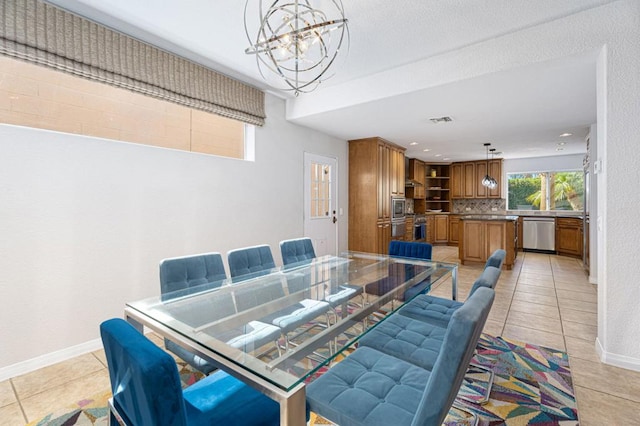 dining room featuring light tile patterned floors and a chandelier