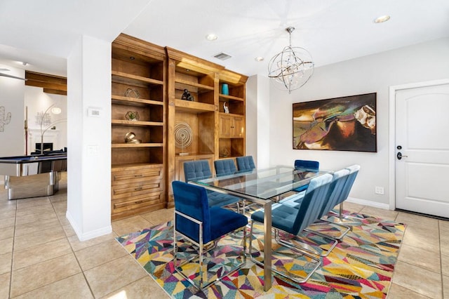 tiled dining area with a chandelier and built in shelves