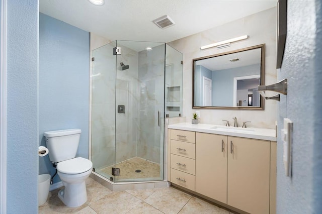 bathroom featuring walk in shower, tile patterned floors, vanity, and toilet