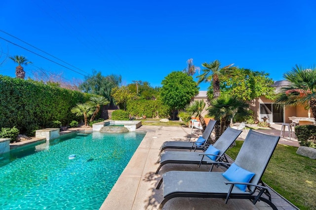 view of pool with a jacuzzi and a patio