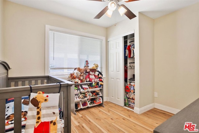 bedroom with wood-type flooring, ceiling fan, and a closet