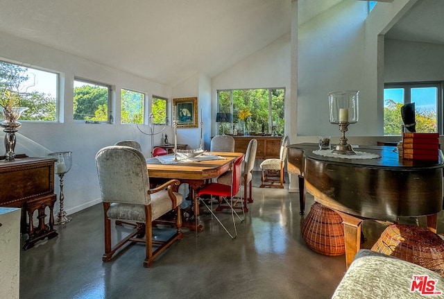 dining space with high vaulted ceiling and a healthy amount of sunlight