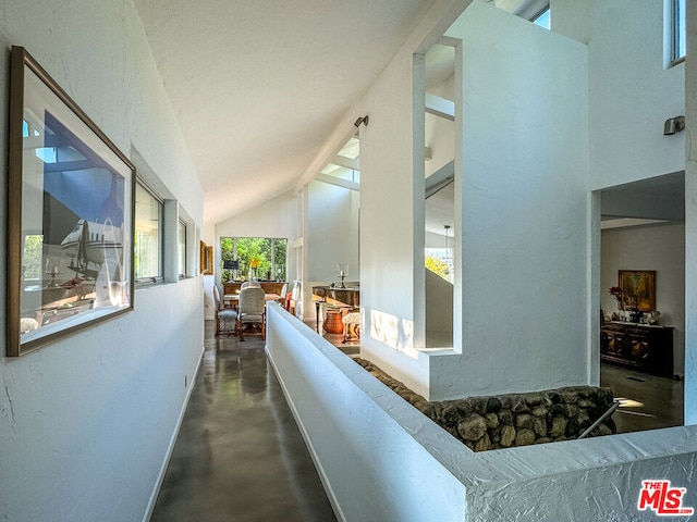 hallway with lofted ceiling