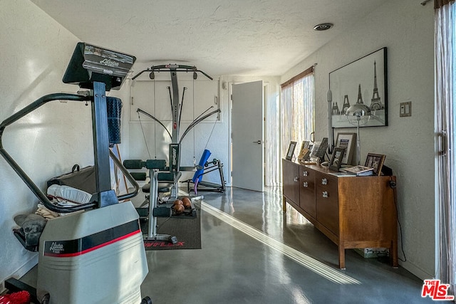 workout area with a textured ceiling