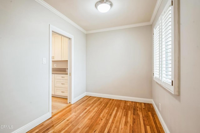 unfurnished bedroom featuring ornamental molding, multiple windows, and light wood-type flooring