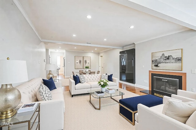 living room featuring crown molding and light wood-type flooring