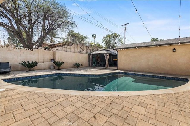 view of swimming pool featuring a gazebo and a patio area