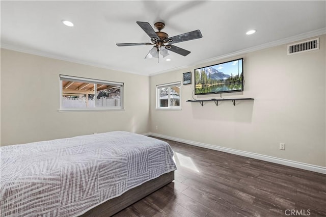 bedroom with dark hardwood / wood-style flooring, ornamental molding, and ceiling fan