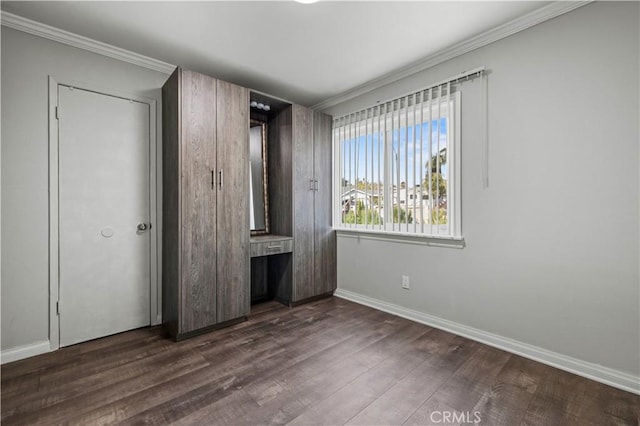 unfurnished bedroom featuring ornamental molding and dark hardwood / wood-style flooring