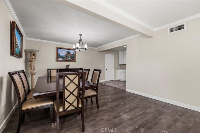 dining area featuring dark hardwood / wood-style flooring, ornamental molding, and a chandelier