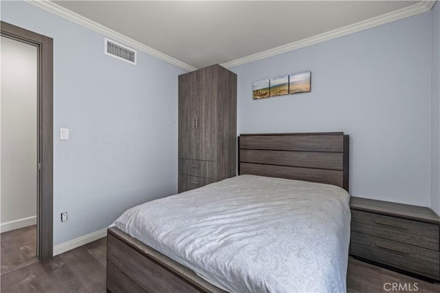 bedroom with dark hardwood / wood-style flooring and crown molding