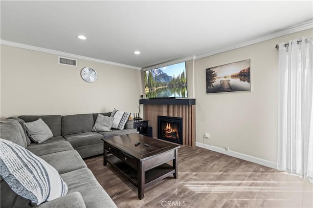 living room featuring crown molding and hardwood / wood-style floors