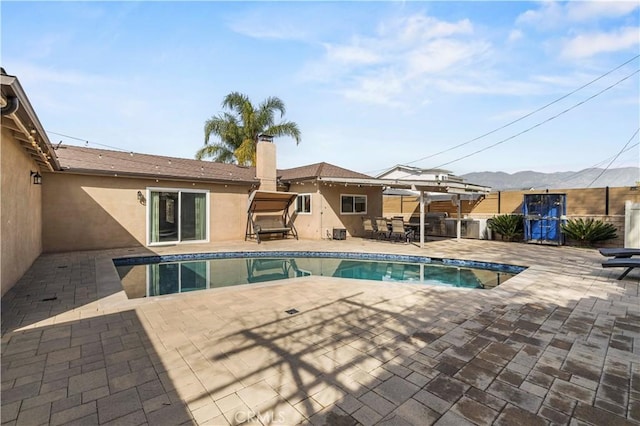 view of pool featuring a mountain view and a patio area